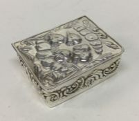 A chased hinged top English silver box with cherub