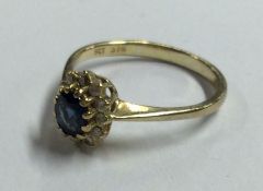 An oval sapphire and diamond cluster ring. Approx.