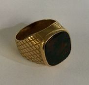 A 9 carat bloodstone set signet ring with engraved