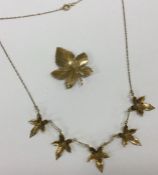 A 9 carat maple leaf necklace together with matchi