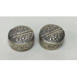 An unusual pair of chased silver menu holders. App