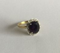 An attractive oval amethyst and diamond cluster ri