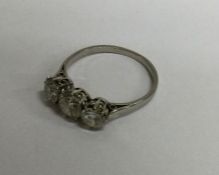 An attractive diamond three stone ring in carved c