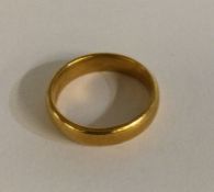 A plain 18 carat gold wedding band. Approx. 6 gram