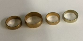 A group of four 9 carat wedding bands. Approx. 10