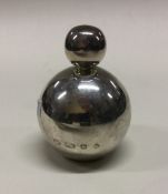 A chased silver scent bottle with embossed decorat