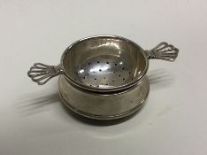 A silver tea strainer. Birmingham 1920. Approx. 55