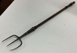 A large George III silver toasting fork. London 18