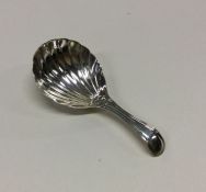 A George III silver caddy spoon with fluted bowl.