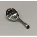 A George III silver caddy spoon with fluted bowl.