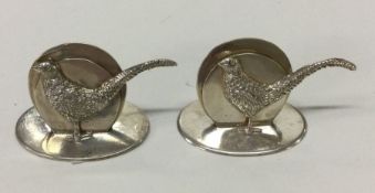 An unusual cast pair of silver menu holders in the