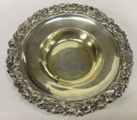 A George III silver gilt dish with chased border.
