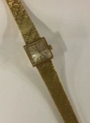 OMEGA: A lady's 9 carat wristwatch on mesh strap.
