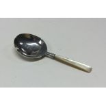 A silver caddy spoon with MOP handle and crest to