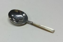 A silver caddy spoon with MOP handle and crest to