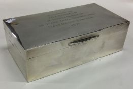 A rectangular silver cigarette box with hinged lid