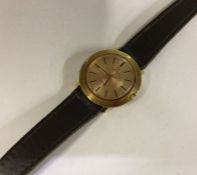 OMEGA: A lady's gold mounted wristwatch on leather