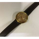 OMEGA: A lady's gold mounted wristwatch on leather