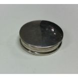A heavy silver pill box with lift-off lid and gilt