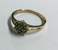 A small green stone cluster ring in 9 carat settin
