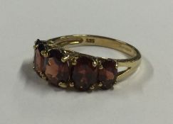 A 9 carat five stone garnet ring. Approx. 3 grams.