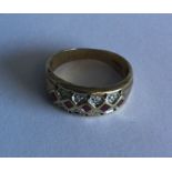 A ruby and diamond mounted three row ring in 9 car