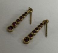 A pair of tapering gold drop earrings. Approx. 1 g