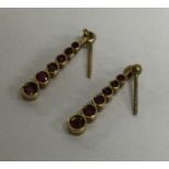 A pair of tapering gold drop earrings. Approx. 1 g