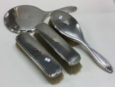 A heavy engine turned silver dressing table set. B