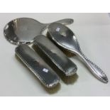 A heavy engine turned silver dressing table set. B