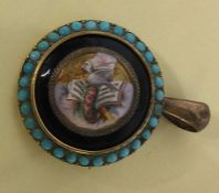 A circular gold and turquoise mounted drop pendant