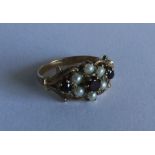 A Victorian style garnet and pearl cluster ring se