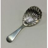 A George III silver caddy spoon with fluted bowl.