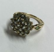 A large 9 carat green stone cluster ring. Approx.