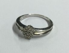 A 9 carat oval diamond cluster ring in claw mount.