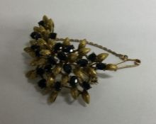 A large 14 carat gold sapphire brooch of floral de