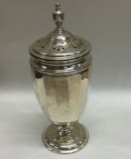 A good quality panelled silver sugar caster of sha