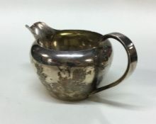 A Russian silver cream jug. Marked to base. Approx