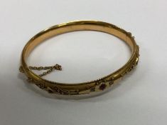 A Victorian ruby and diamond bangle with concealed