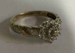 A fancy diamond cluster ring set in 9 carat. Appro