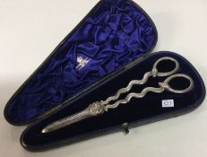 A good pair of silver plated grape scissors contai