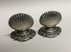 An unusual pair of silver menu holders in the form