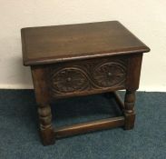 An oak hinged top work table. Est. £25 - £30.