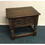 An oak hinged top work table. Est. £25 - £30.