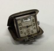 A stylish silver travelling watch. Est. £70 - £80.