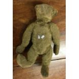 A preloved teddy bear. Est. £20 - £30.