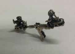 A toy silver see-saw. Approx. 13 grams. Est. £30 -