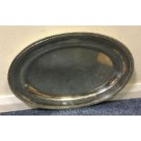 A large oval silver Georgian silver meat dish, wit