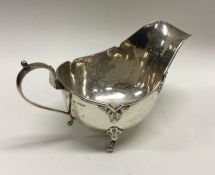A heavy Edwardian silver sauce boat of shaped form