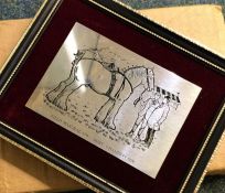 A silver mounted frame decorated with horses in or